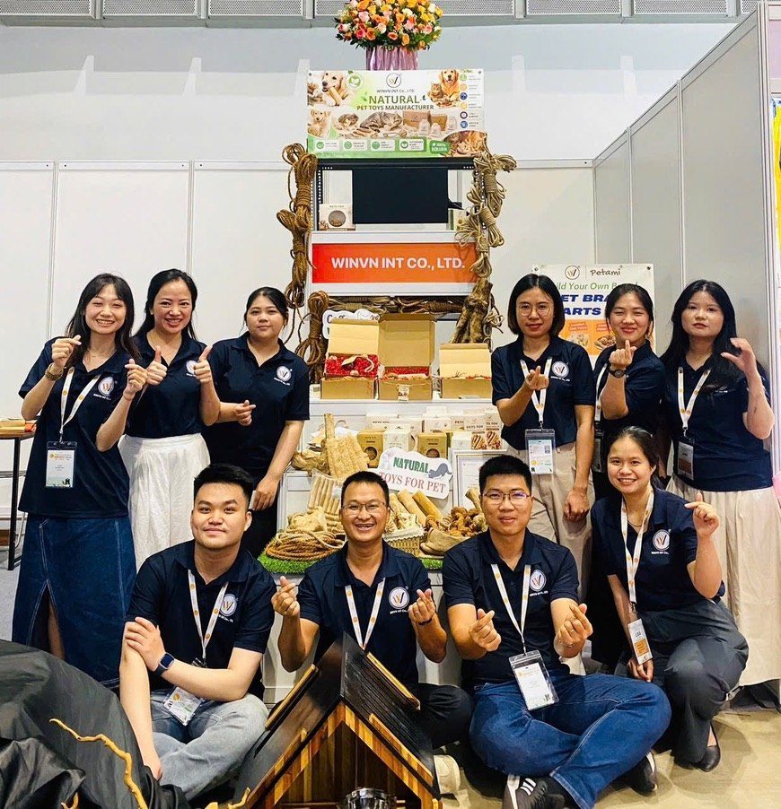 WINVN INT CO., LTD team at a trade show with natural pet toy product displays